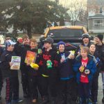 A North Bay Trapper's minor league hockey team holding up food for a food drive